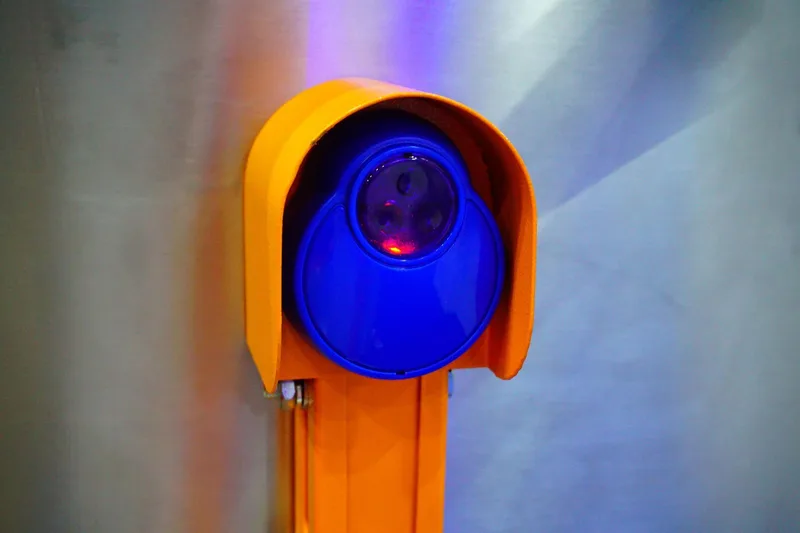 Garage door safety inspection by Santos & Sons in San Mateo — technician testing auto-reverse sensors