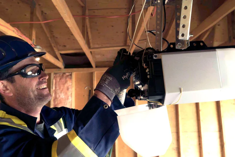 Garage door opener maintenance service in San Mateo — Santos & Sons technician servicing belt-drive opener